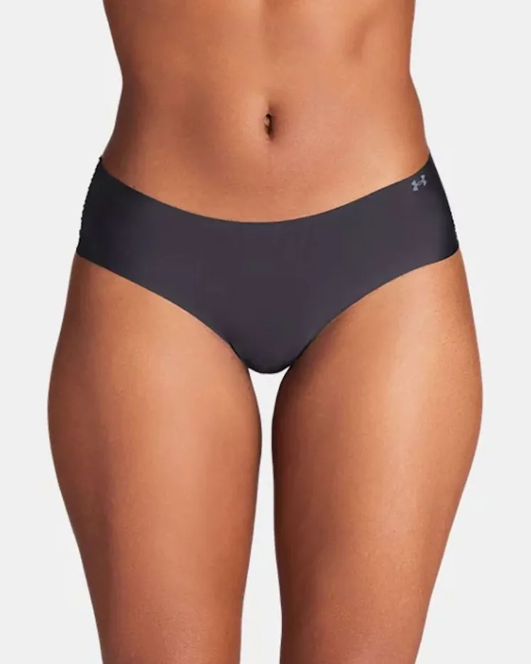 Various styles of women's athletic underwear arranged on a wooden floor.